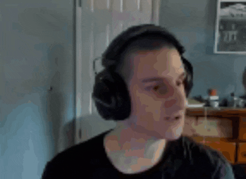 a man wearing headphones and a microphone making a funny face