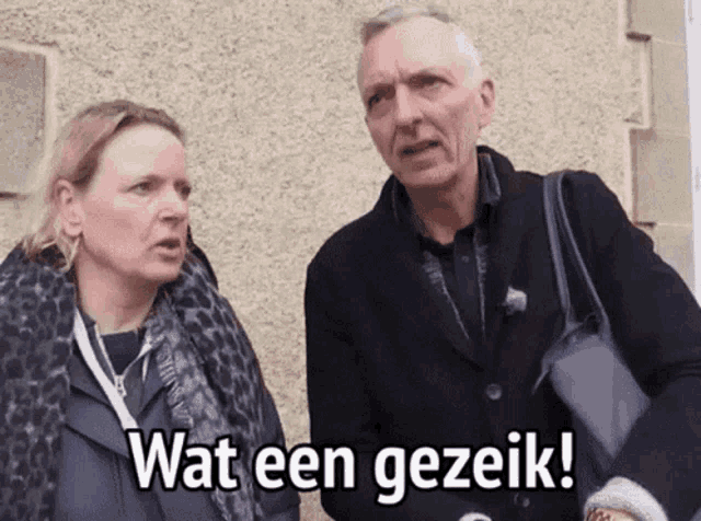 a man and a woman are standing next to each other with the words wat een gezeik written above them