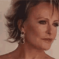 a close up of a woman 's face wearing a pair of earrings