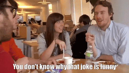 a group of people sitting at a table with a bottle of aquafina water