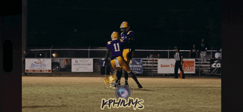 a group of football players are on a field with a sign that says jason terrell in the background