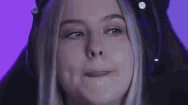 a young woman wearing headphones is making a funny face .
