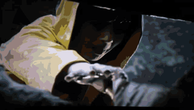 a man in a yellow jacket is holding something in his hands