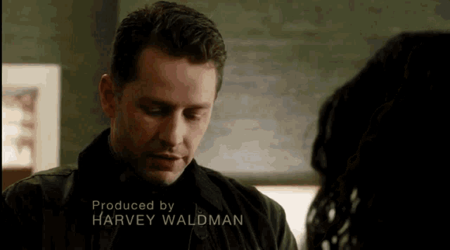 a man talking to a woman with the name harvey waldman on the bottom right