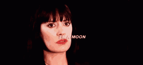 a close up of a woman 's face with the words `` i 'm a moon '' written on her face .