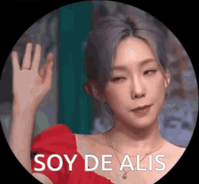 a woman in a red dress is waving her hand in a circle that says soy de alis on it
