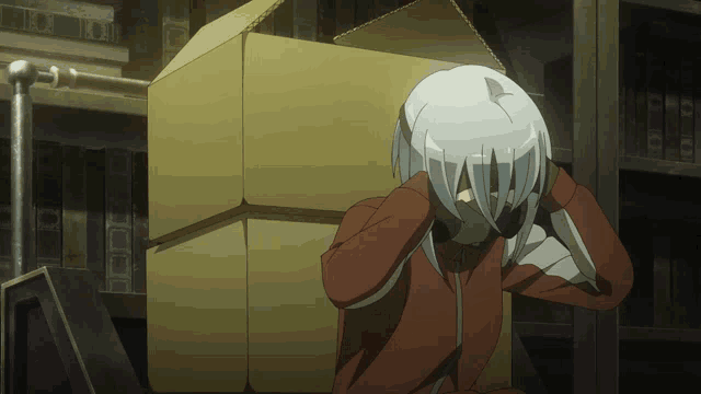 a person covering their face with their hands in front of a box