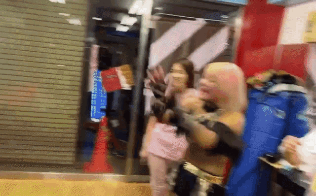 a blurry photo of a group of people standing in front of a store