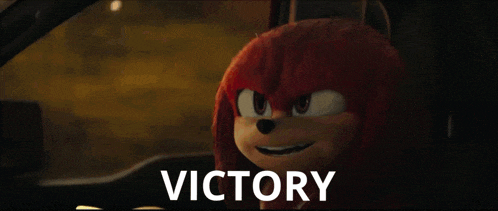 knuckles the echidna from the movie sonic the hedgehog is smiling in a car with the word victory behind him .