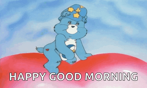 a care bear is sitting on top of a red heart with the words `` happy good morning '' written below it .