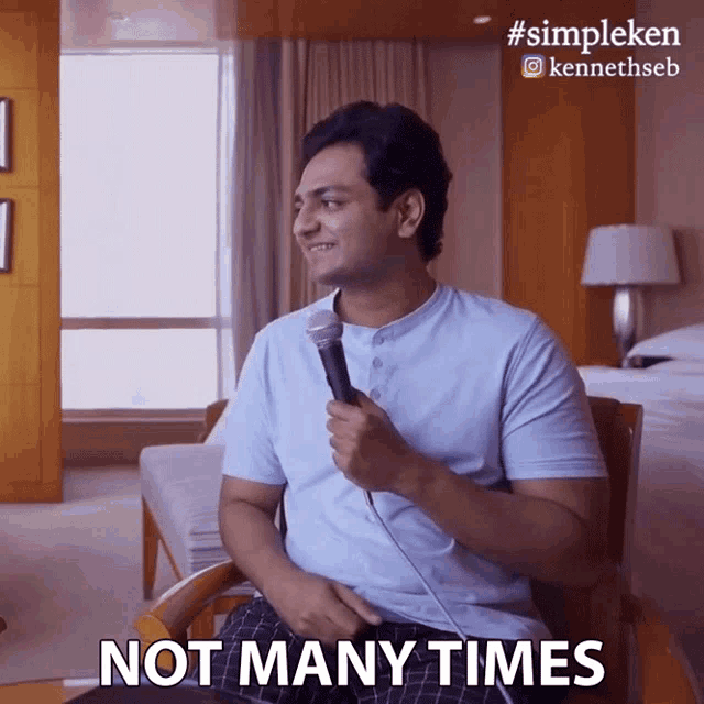 a man sitting in a chair with a microphone says " not many times "