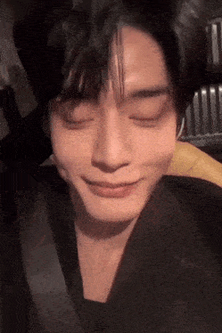 a close up of a person 's face with their eyes closed and a smile on their face .