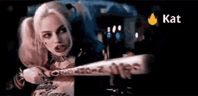 harley quinn from suicide squad is holding a bat in her right hand .