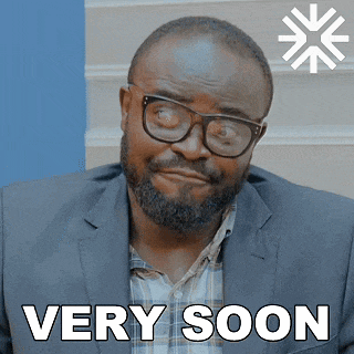 a man wearing glasses and a suit has the words very soon on his face