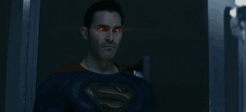 a man in a superman costume has a light coming out of his eye
