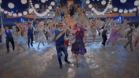 a group of people are dancing in a room with lights