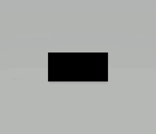 a black rectangle is sitting on a gray surface .