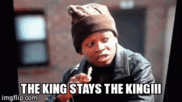 a man wearing a beanie and a leather jacket is smoking a cigarette .
