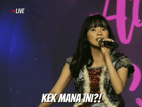 a girl singing into a microphone with the words kek mana ini written below her