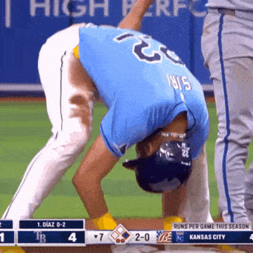 a baseball player in a blue shirt with the number 22 on it