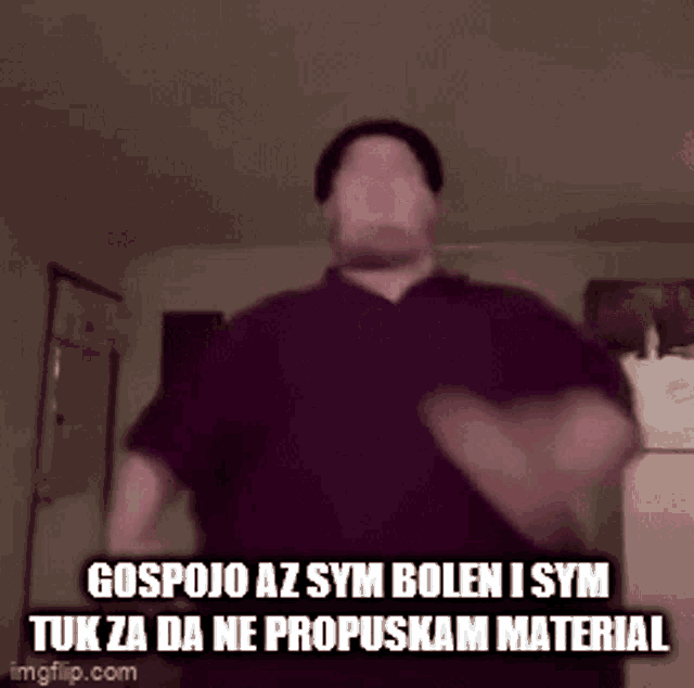 a man in a purple shirt is dancing in a room with a caption .