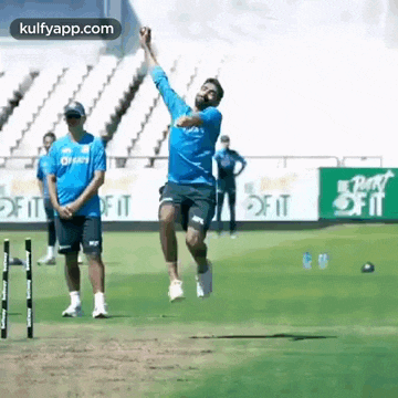 a man is throwing a ball in the air on a field .