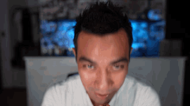 a close up of a man 's face in front of a computer screen