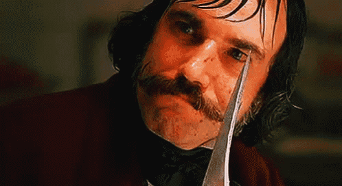 a man with a mustache is holding a sword in his hand
