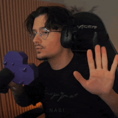 a man wearing headphones and a black shirt that says nabi on it