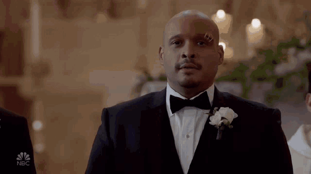 a man in a tuxedo and bow tie has a bandage on his eye