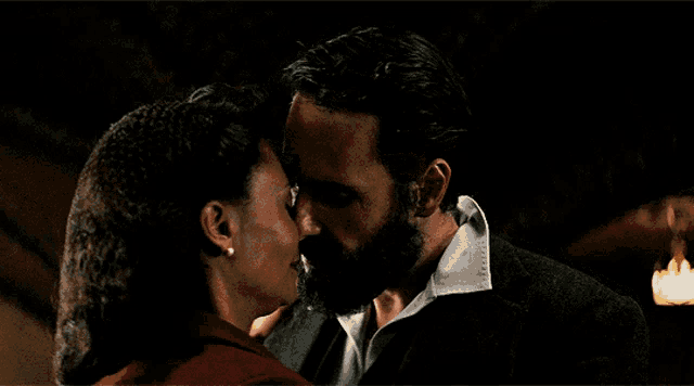 a man and a woman are looking at each other with their eyes closed