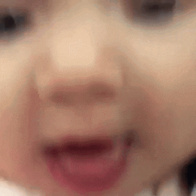 a close up of a baby 's face with a blurred background