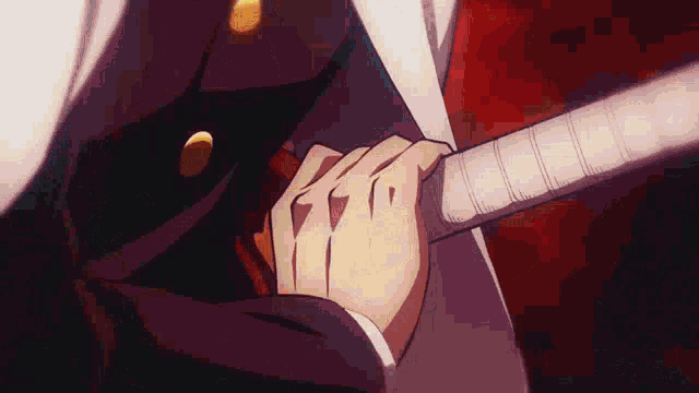 a person is holding a sword in their hand in a close up .