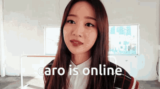 a woman is standing in front of a window with the words caro is online written on the bottom