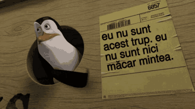 a penguin is sticking his head out of a hole next to a piece of paper that says eu nu sunt acest trup