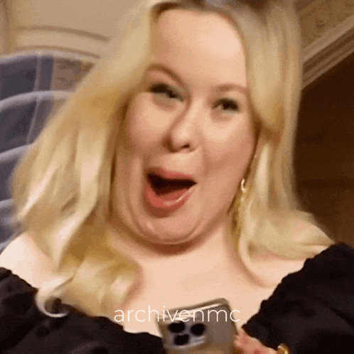 a woman is making a funny face and the words archivenmc are behind her