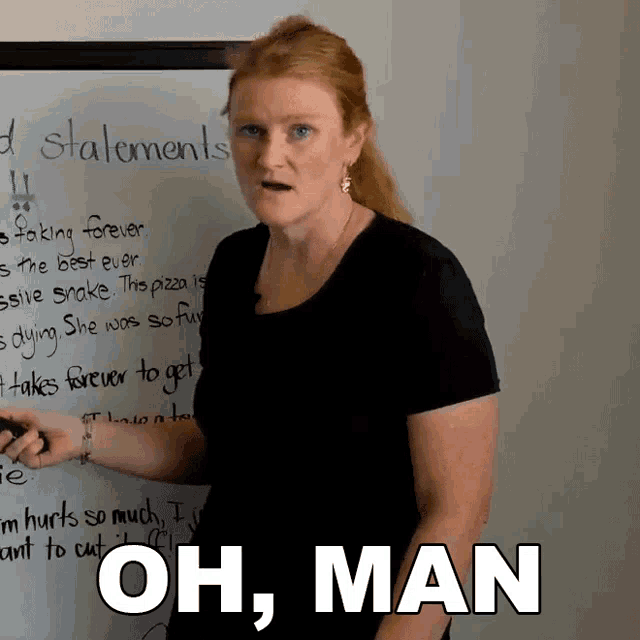 a woman is standing in front of a white board with the words oh man written on it