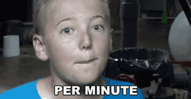 a young boy in a blue shirt says per minute on his face