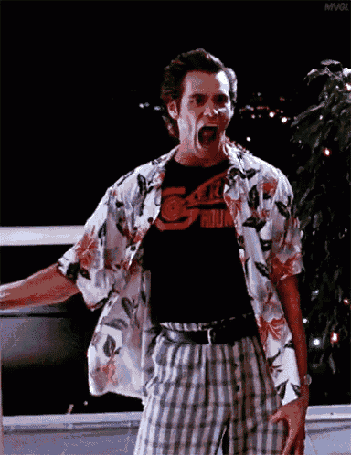 a man wearing a hawaiian shirt and plaid shorts is screaming with his mouth open
