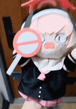 a stuffed animal with headphones and a no entry sign