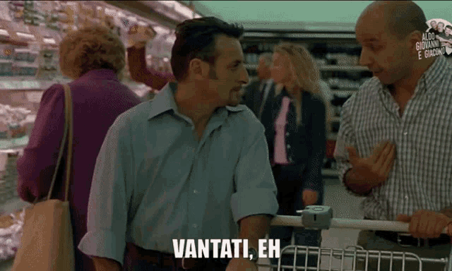 a man in a blue shirt is talking to another man in a grocery store and says vantati eh
