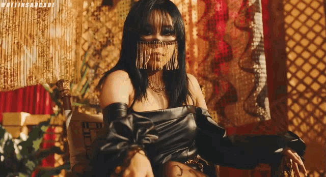 a woman with fringe on her face is sitting in a chair with the words wakeinsarcade on the bottom
