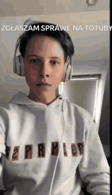 a young man wearing headphones and a white hoodie with the word harry on it