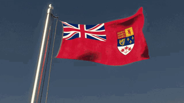 a red and white flag with a coat of arms on it