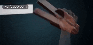 a person is holding a gun in their hand in the dark .