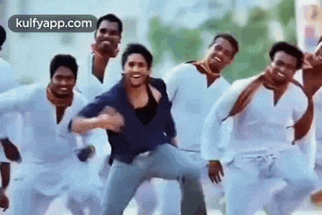 a group of men are dancing together in a room .