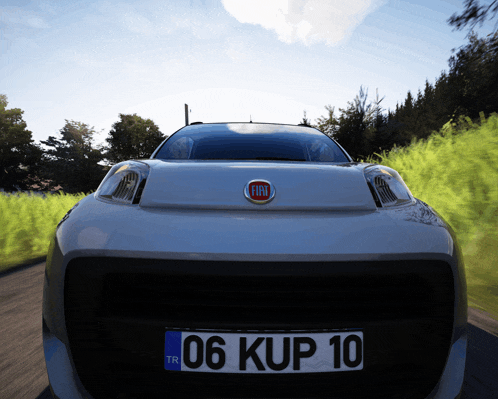 the front of a silver fiat car with a license plate that says 06 kup 10