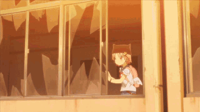 a girl in a cat hat looks out a broken window