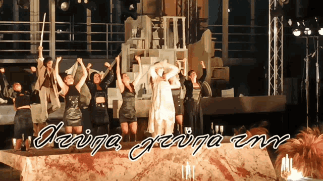 a group of women are dancing in front of a sign that says ' devina george emr '