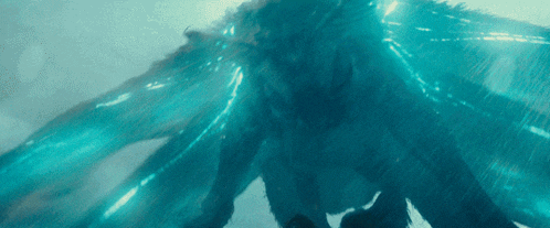 a close up of a creature with blue wings